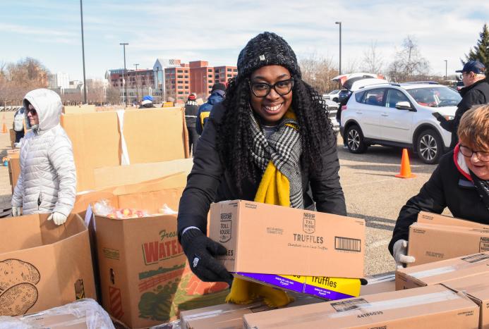 Woman grabbing box of food