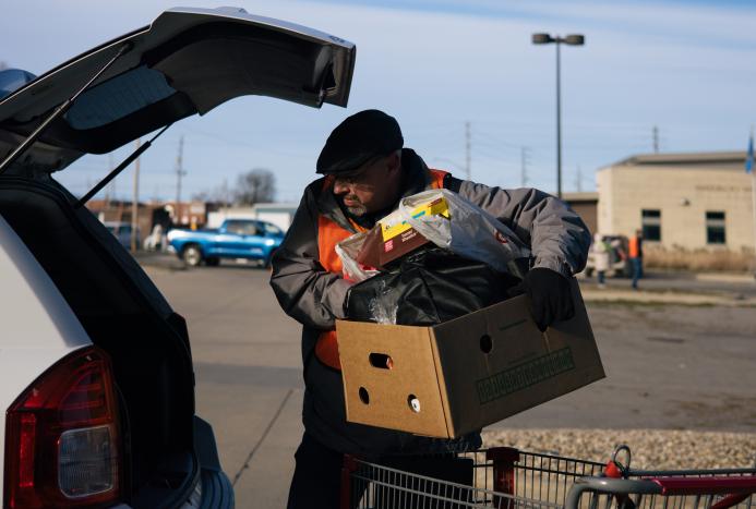 man loading food into a trunk