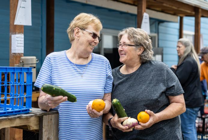 two women holding food