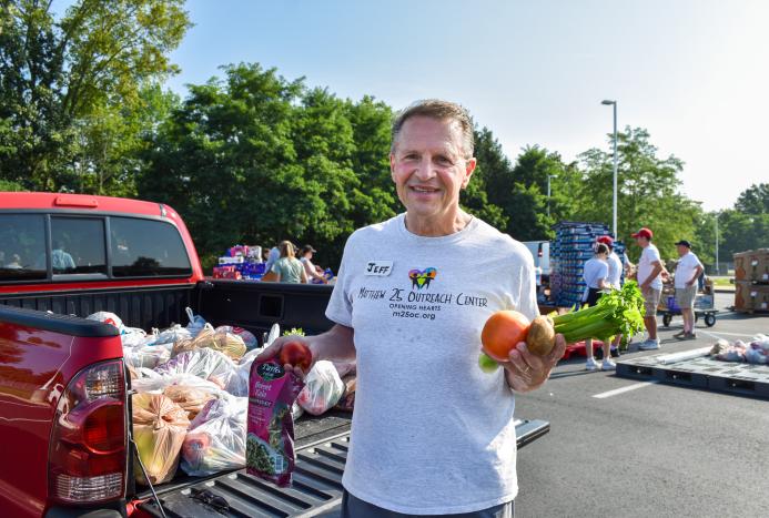 man holding produce