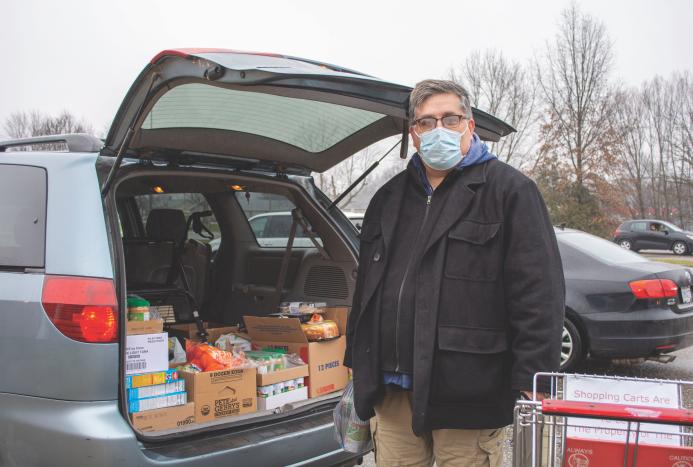 person with food in trunk of car