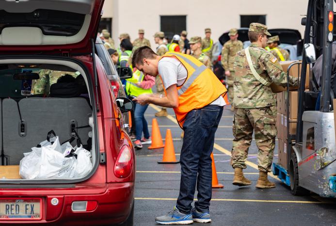 person loading food into car