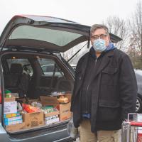 person with food in trunk of car