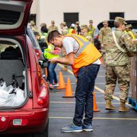 person loading food into car